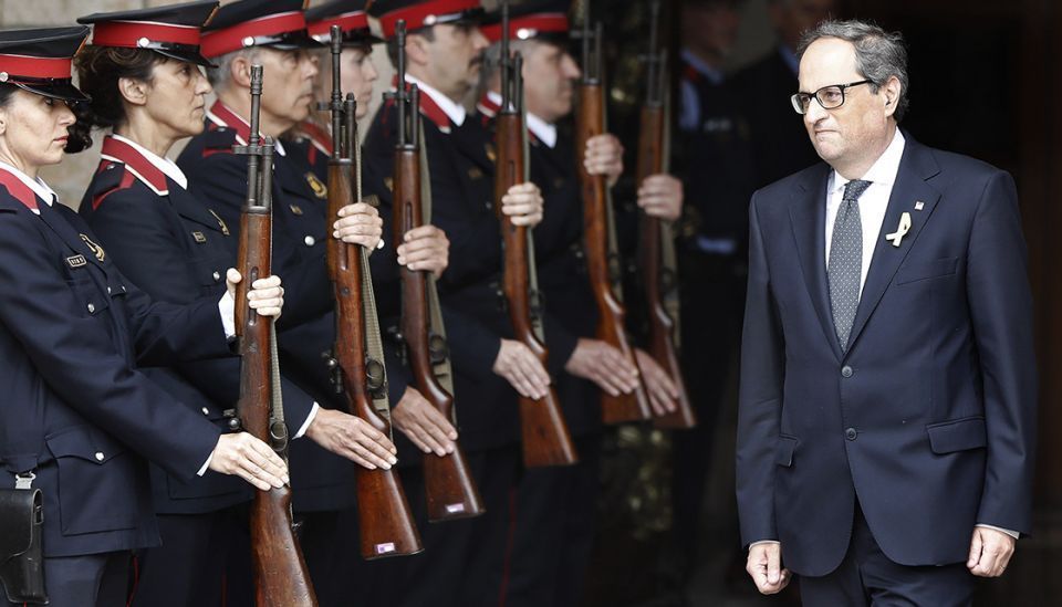 El nuevo presidente de la Generalitat, Quim Torra, sale del edificio del Parlament ante la formación de gala de los Mossos d'Esquadra. / EFE